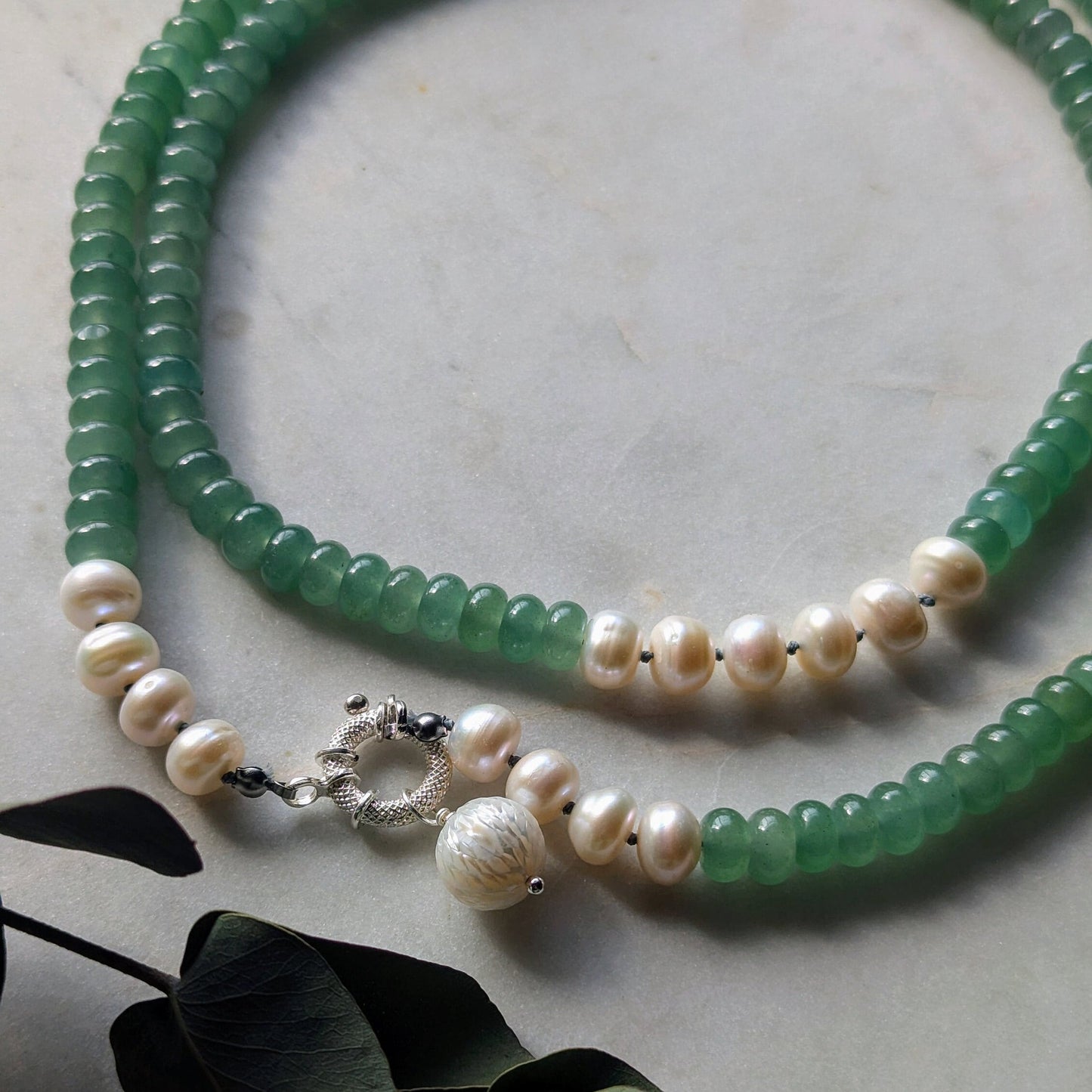 Knotted gemstone pearl necklace with hand-carved pendant