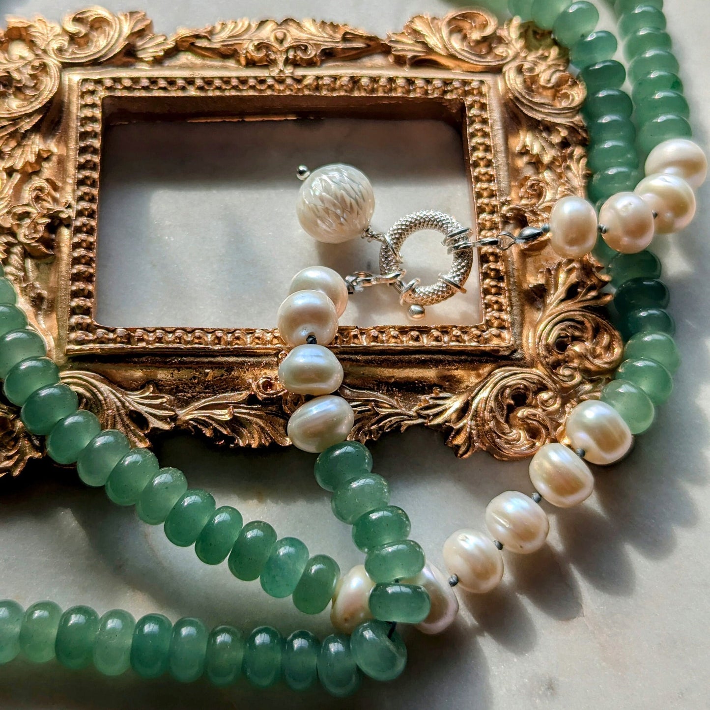 Knotted gemstone pearl necklace with hand-carved pendant