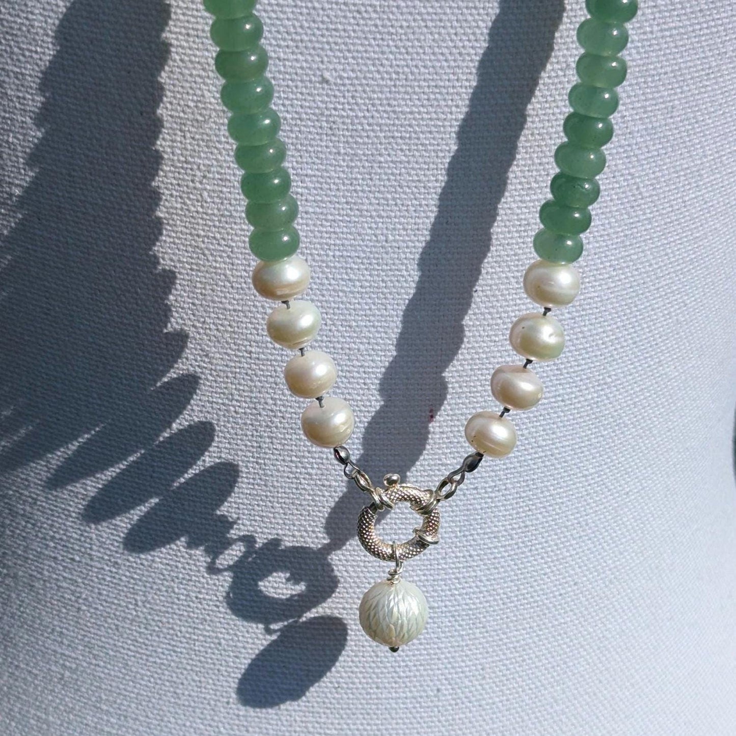 Knotted gemstone pearl necklace with hand-carved pendant