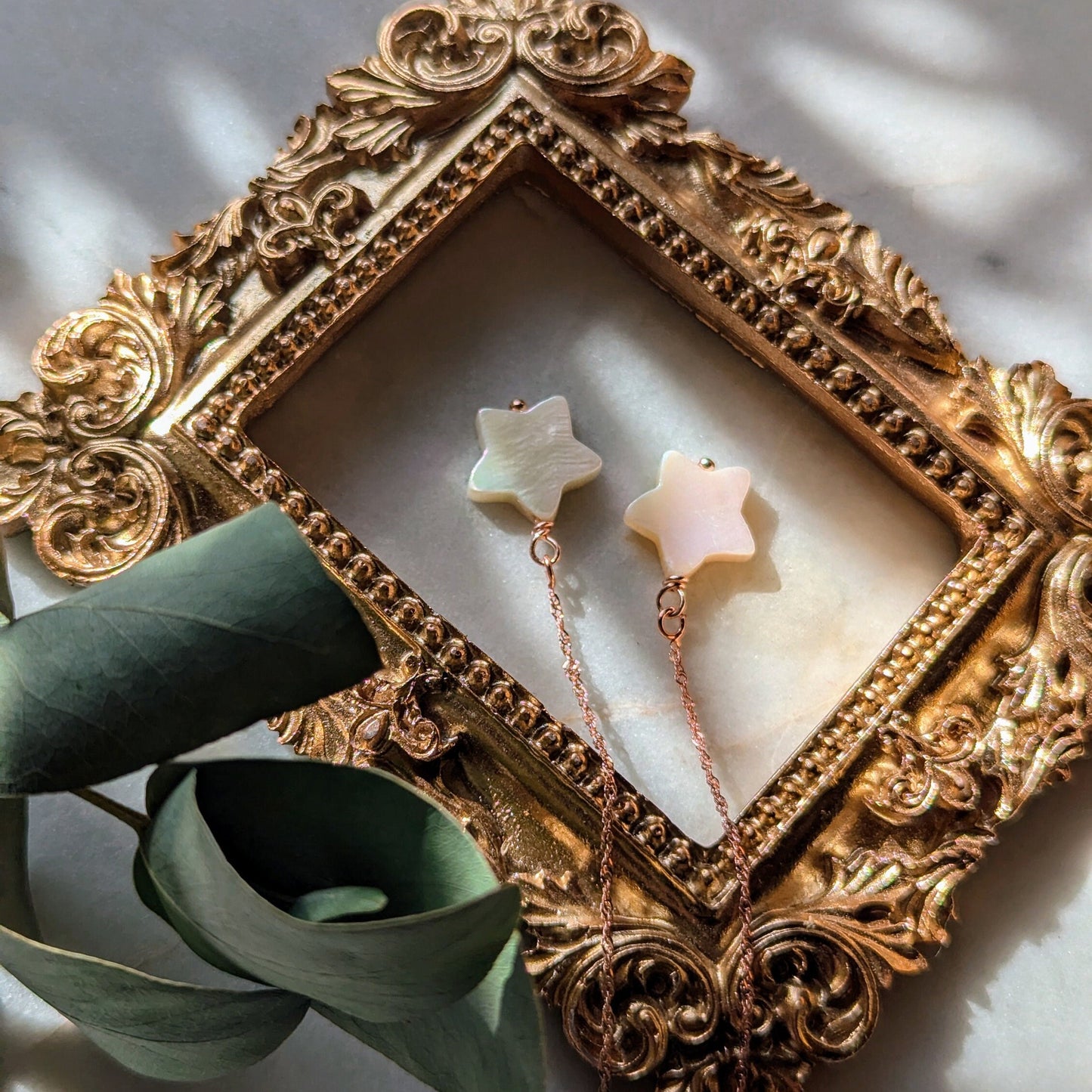 Boucles d'oreilles en fil d'or rose avec étoiles en nacre