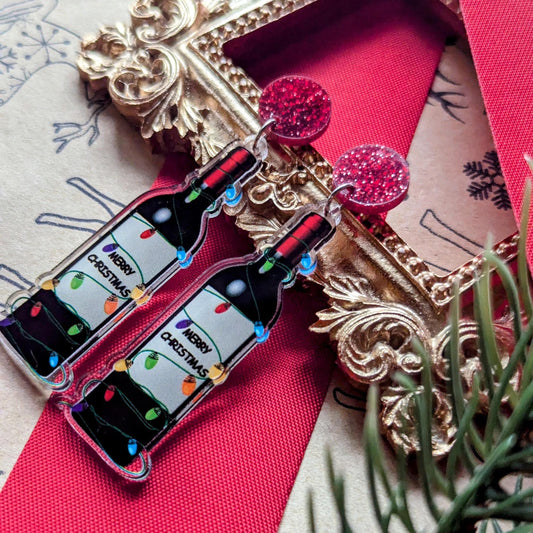 Boucles d'oreilles de Noël amusantes avec une bouteille de vin