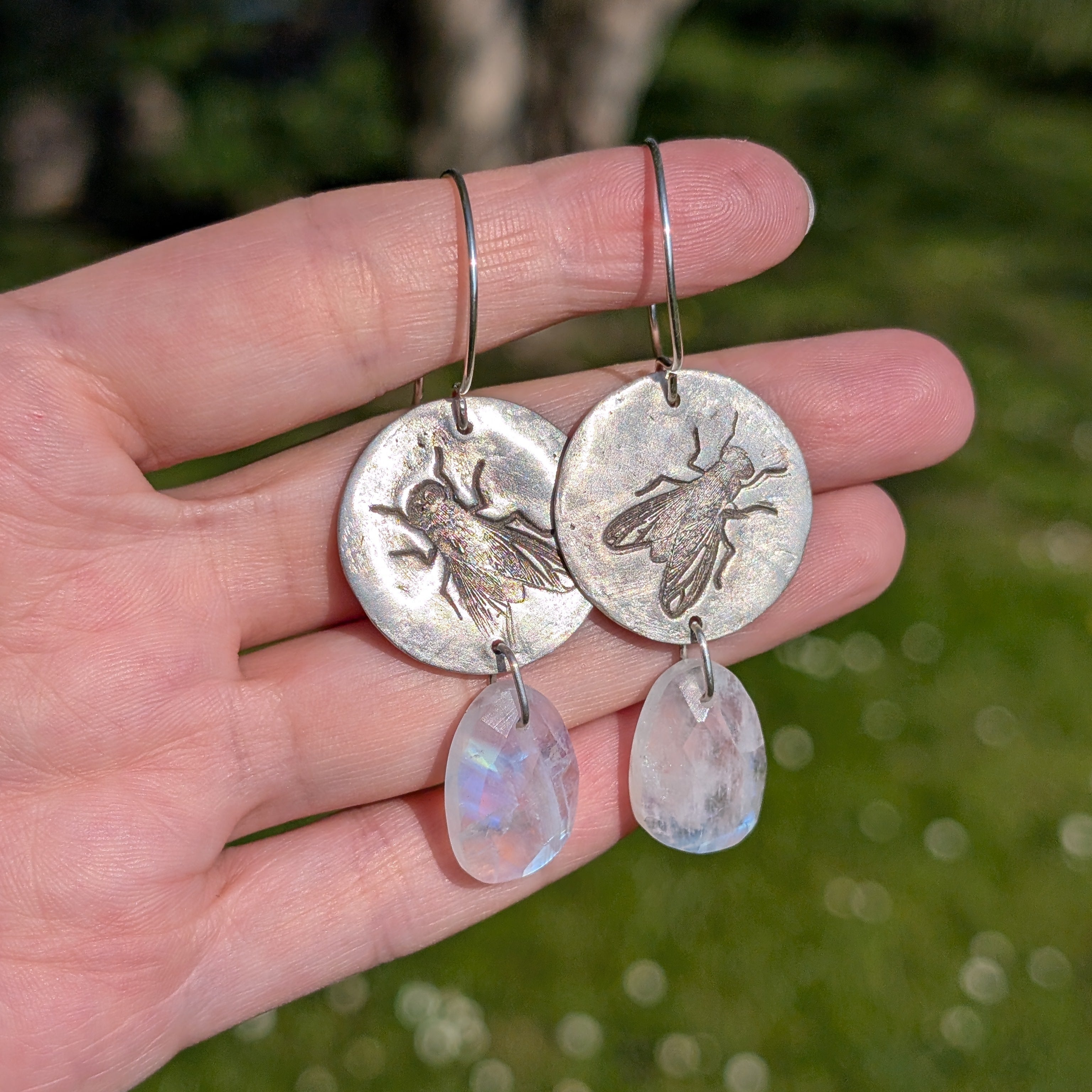Handgefertigte Ohrringe aus Silber mit feinem Insektenrelief und Mondstein